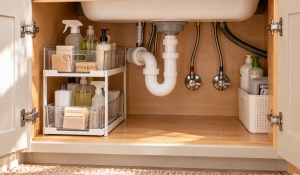 Organized sink cabinet with clear access to plumbing and shutoff valves